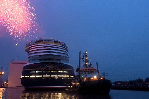 OCTOBER 30, 2010): As pyrotechnics light the sky, the Disney Dream cruise ship makes its first public appearance Oct. 30, 2010 in Papenburg, Germany as it floats out of an enclosed building dock, pulled by a tugboat, at the Meyer Werft shipyard. Thousands of local residents gathered to see the "float out" ceremony. The new ship is scheduled to sail its maiden voyage Jan. 26, 2011 from Port Canaveral, Fla. (Diana Zalucky, photographer) 