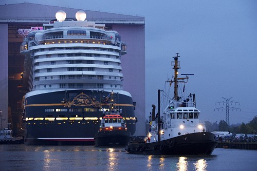 (OCTOBER 30, 2010): The Disney Dream cruise ship makes its first public appearance Oct. 30, 2010 in Papenburg, Germany as it begins to exit an enclosed building dock, pulled by a tugboat, at the Meyer Werft shipyard. Thousands of local residents gathered to see the "float out" ceremony. The new ship is scheduled to sail its maiden voyage Jan. 26, 2011 from Port Canaveral, Fla. (Diana Zalucky, photographer)